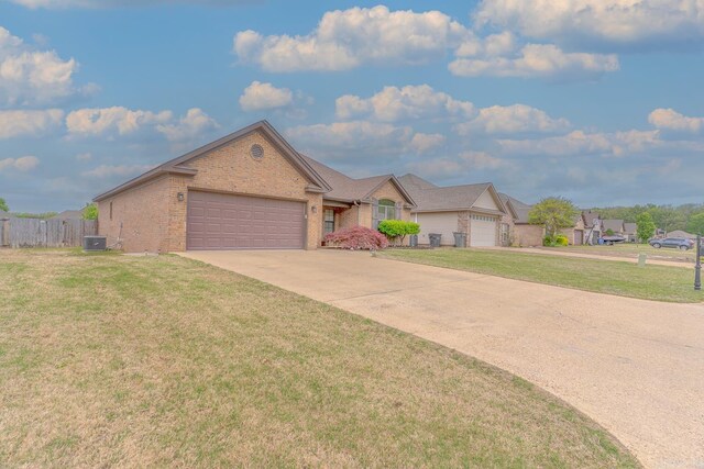 6037 Beaver Creek Ln, Jones Creek, AR 72404 - ranch-style house with driveway, central AC, brick siding, an attached garage, and a front yard
