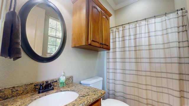 bathroom featuring vanity, a shower with shower curtain, ornamental molding, and toilet