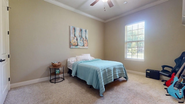 carpeted bedroom with ceiling fan, baseboards, and ornamental molding