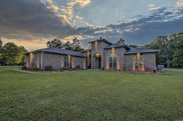 view of front of property featuring brick siding and a front yard