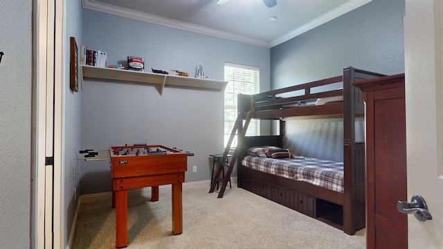 bedroom featuring a ceiling fan, carpet floors, crown molding, and baseboards