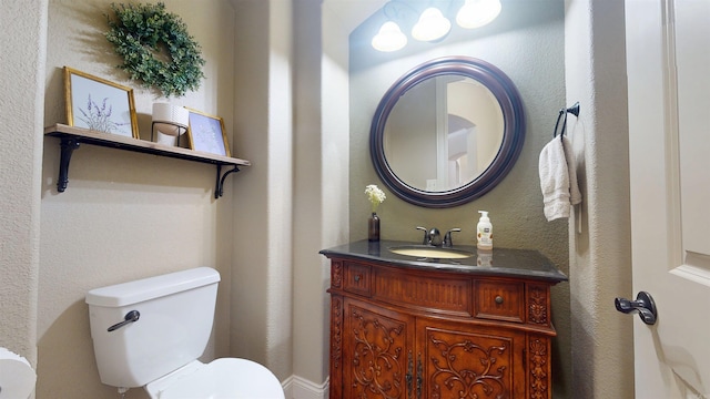 half bathroom with vanity and toilet