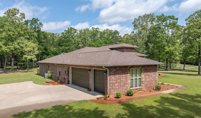 view of side of property with brick siding, a yard, roof with shingles, and a garage