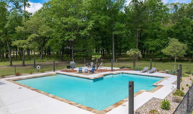 view of pool featuring a patio area, a fenced in pool, and fence