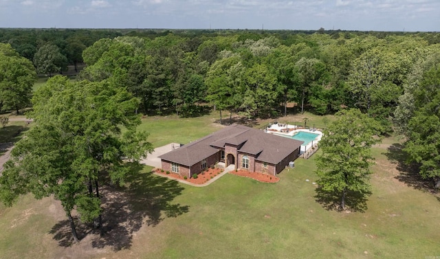 bird's eye view with a wooded view