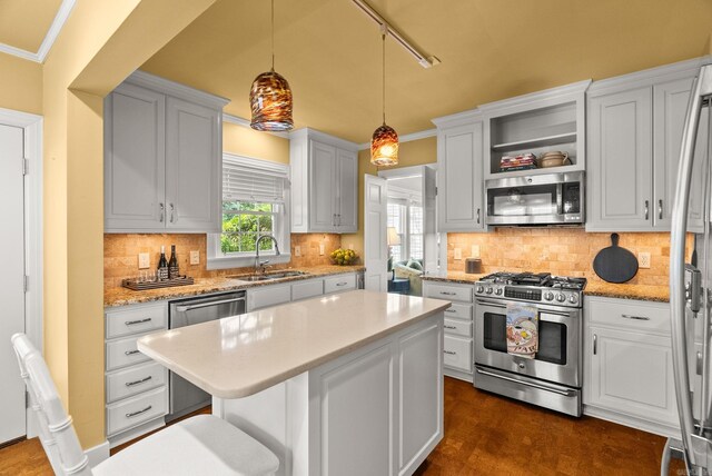 5715 Hawthorne Rd, Little Rock, AR 72207 - kitchen with dark wood-style floors, stainless steel appliances, open shelves, a sink, and a kitchen island