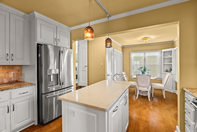 5715 Hawthorne Rd, Little Rock, AR 72207 - kitchen with white cabinets, crown molding, stainless steel refrigerator with ice dispenser, and a center island