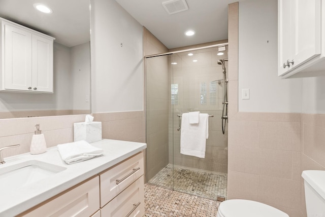 5715 Hawthorne Rd, Little Rock, AR 72207 - full bath with a stall shower, tile walls, a wainscoted wall, toilet, and visible vents