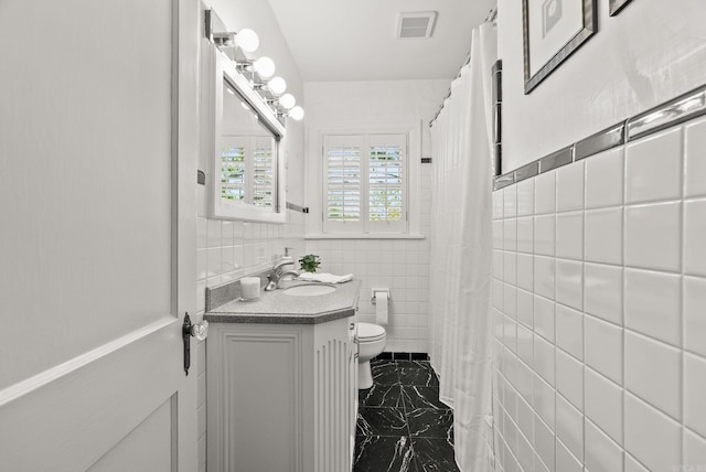 5715 Hawthorne Rd, Little Rock, AR 72207 - bathroom featuring vanity, tile walls, marble finish floor, toilet, and visible vents