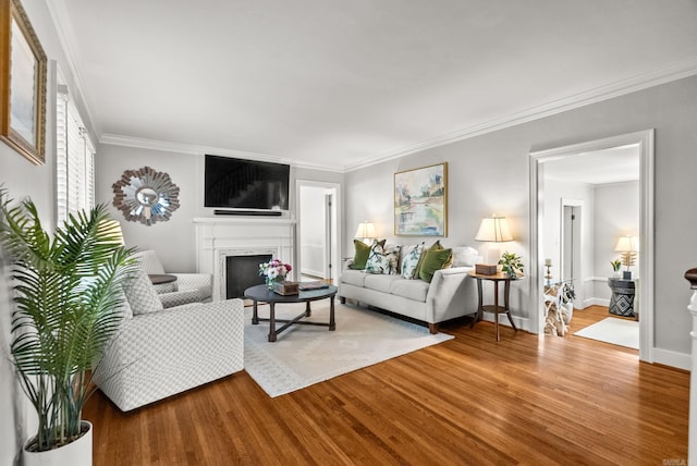 5715 Hawthorne Rd, Little Rock, AR 72207 - living room with baseboards, crown molding, wood finished floors, and a fireplace
