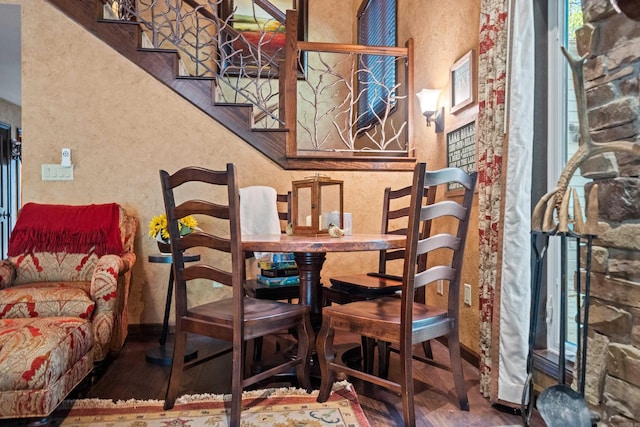 dining space with stairway, baseboards, and a textured wall
