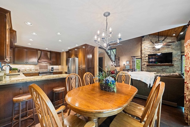 dining area with recessed lighting, wood finished floors, and an inviting chandelier