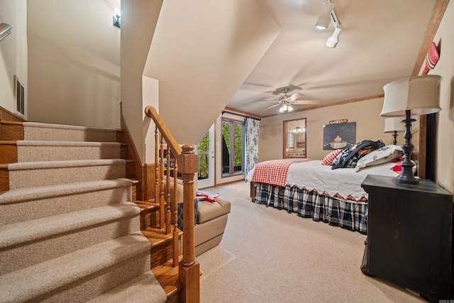 bedroom with a ceiling fan, rail lighting, access to outside, carpet flooring, and visible vents