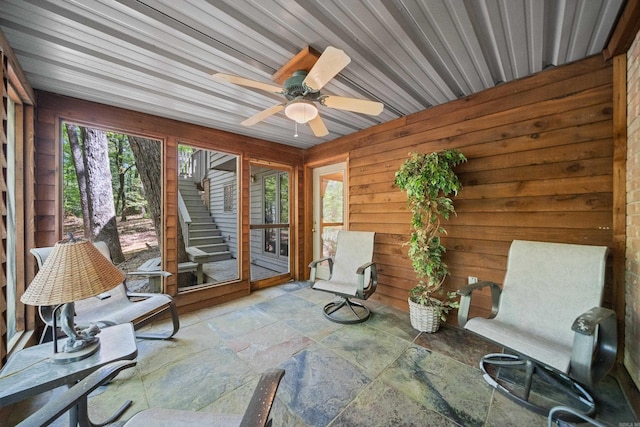 unfurnished sunroom with a ceiling fan
