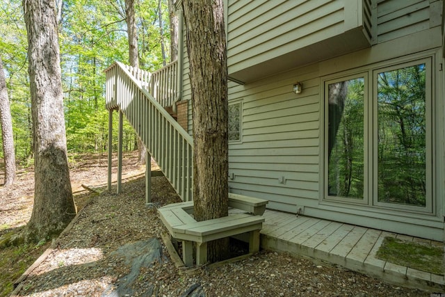 view of side of property featuring a wooden deck and stairs