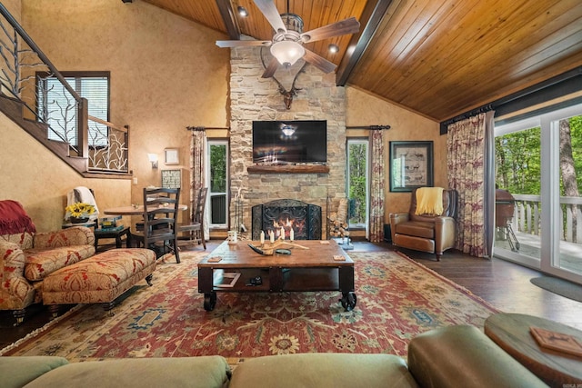 living room with beamed ceiling, wood finished floors, stairs, ceiling fan, and wood ceiling