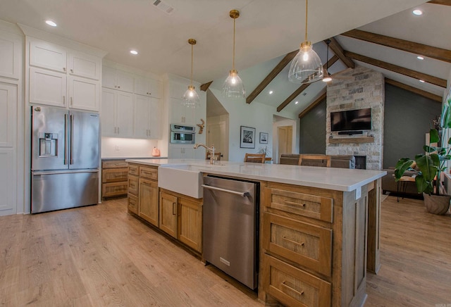 4941 Lake Vista Dr, Benton, AR 72019 - kitchen with stainless steel appliances, visible vents, a sink, light wood-style floors, and open floor plan