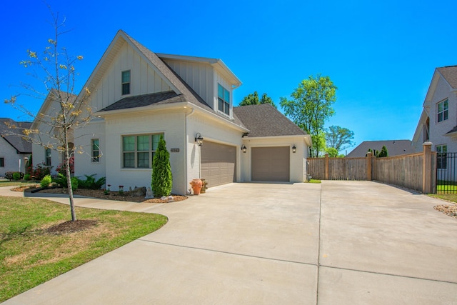 4941 Lake Vista Dr, Benton, AR 72019 - view of front of house featuring concrete driveway, fence, board and batten siding, and a shingled roof