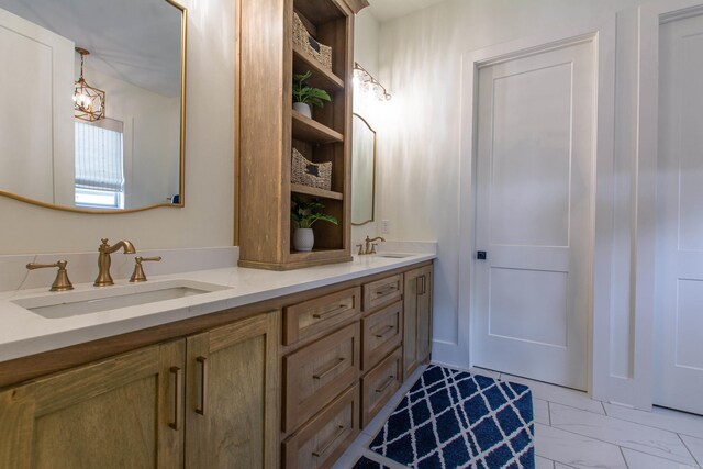 4941 Lake Vista Dr, Benton, AR 72019 - bathroom featuring marble finish floor, a chandelier, a sink, and double vanity