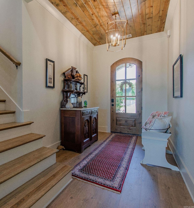 4941 Lake Vista Dr, Benton, AR 72019 - entryway featuring stairway, wood finished floors, a chandelier, wood ceiling, and arched walkways