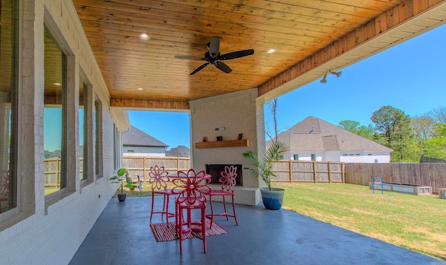 4941 Lake Vista Dr, Benton, AR 72019 - view of patio featuring an outdoor brick fireplace, a fenced backyard, and ceiling fan