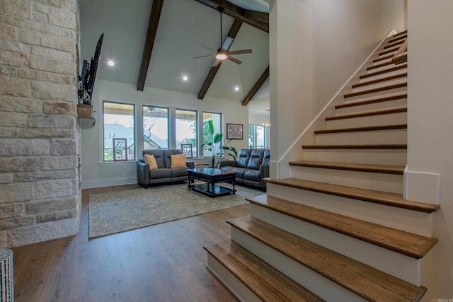 4941 Lake Vista Dr, Benton, AR 72019 - living area featuring wood finished floors, stairs, a ceiling fan, beam ceiling, and high vaulted ceiling