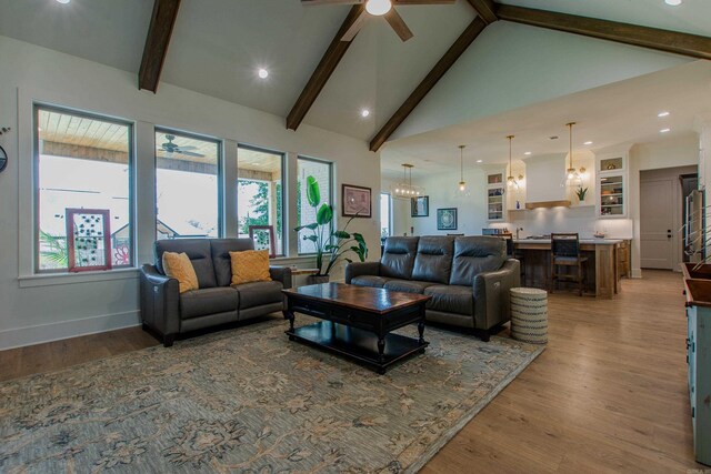 4941 Lake Vista Dr, Benton, AR 72019 - living area with wood finished floors, beam ceiling, ceiling fan, and a healthy amount of sunlight
