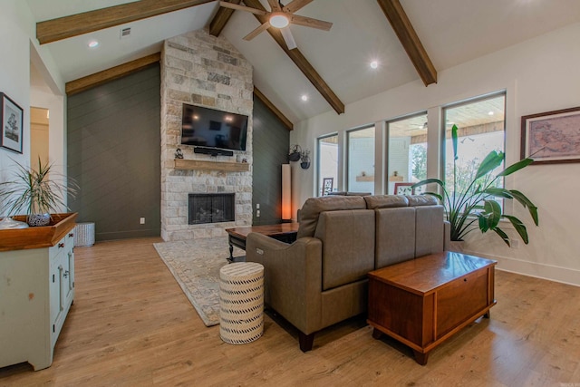 4941 Lake Vista Dr, Benton, AR 72019 - living room featuring a stone fireplace, a ceiling fan, beamed ceiling, light wood-style flooring, and high vaulted ceiling