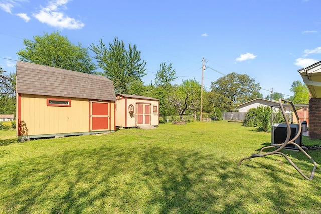 15 Falcon Dr, Sherwood, AR 72120 - view of yard featuring fence, a storage unit, and an outdoor structure