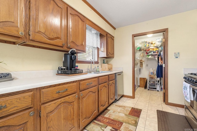 15 Falcon Dr, Sherwood, AR 72120 - kitchen with light countertops, brown cabinetry, stainless steel appliances, and a sink