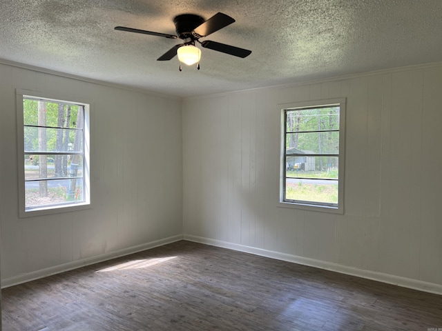 unfurnished room featuring plenty of natural light, a textured ceiling, ceiling fan, and dark wood-style flooring