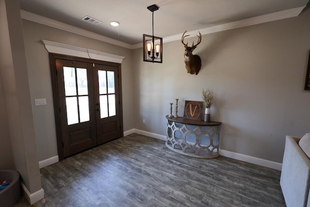 foyer entrance with wood finished floors, visible vents, french doors, crown molding, and baseboards