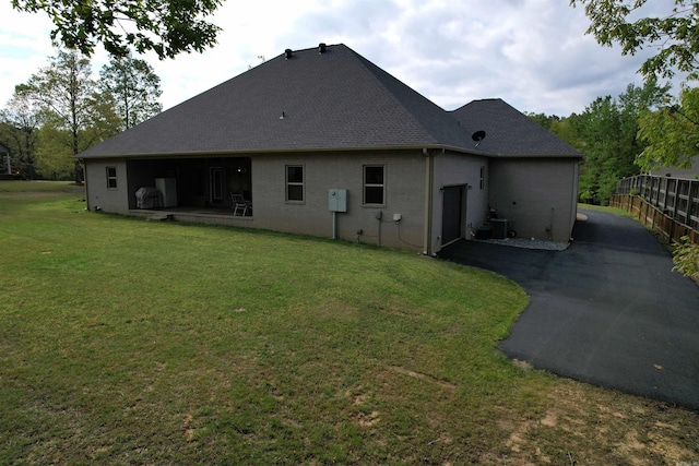 2780 Shoemaker Rd, Sheridan, AR 72150 - back of property with aphalt driveway, fence, and a yard