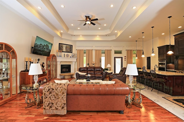 2780 Shoemaker Rd, Sheridan, AR 72150 - living room featuring a tray ceiling, recessed lighting, wood finished floors, ceiling fan, and crown molding