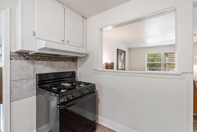 7803 Ascension Rd, Little Rock, AR 72204 - kitchen featuring tasteful backsplash, black gas range, white cabinetry, wood finished floors, and under cabinet range hood