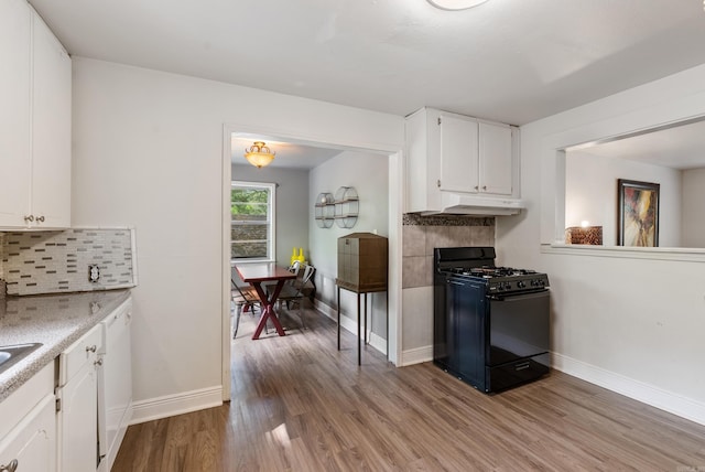7803 Ascension Rd, Little Rock, AR 72204 - kitchen featuring wood finished floors, baseboards, black range with gas stovetop, and under cabinet range hood