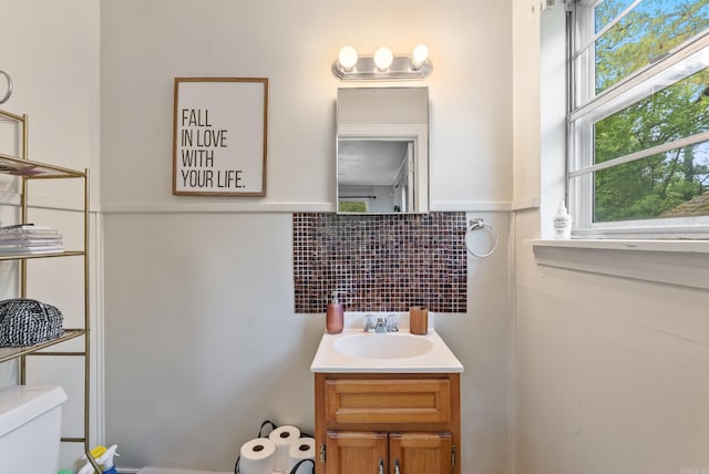 7803 Ascension Rd, Little Rock, AR 72204 - bathroom featuring toilet, tasteful backsplash, vanity, and plenty of natural light