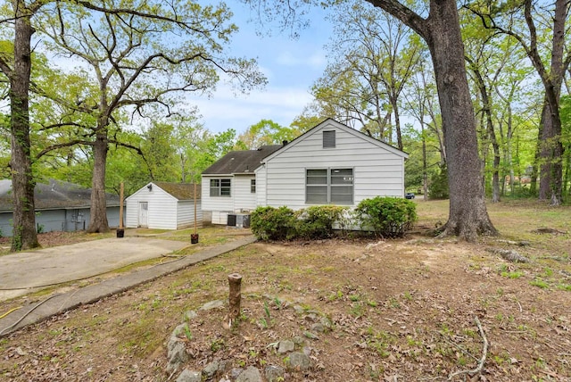7803 Ascension Rd, Little Rock, AR 72204 - view of front facade with an outbuilding, a storage shed, and central AC