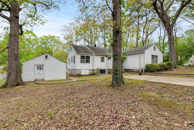 7803 Ascension Rd, Little Rock, AR 72204 - rear view of property with an outdoor structure and central AC
