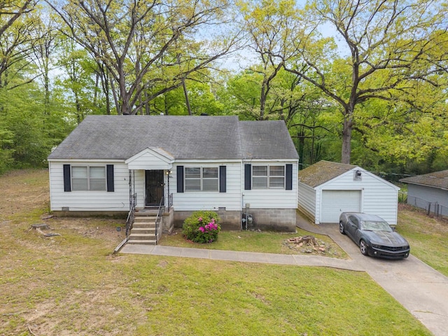 7803 Ascension Rd, Little Rock, AR 72204 - view of front of property with concrete driveway, a front lawn, an outbuilding, and a garage
