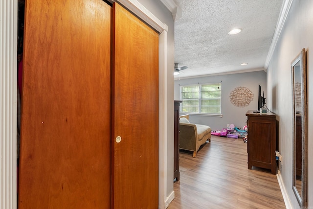 7803 Ascension Rd, Little Rock, AR 72204 - corridor with baseboards, crown molding, a textured ceiling, and light wood-style floors