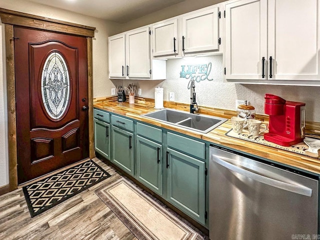 kitchen with white cabinets, dishwasher, wood finished floors, a sink, and butcher block countertops