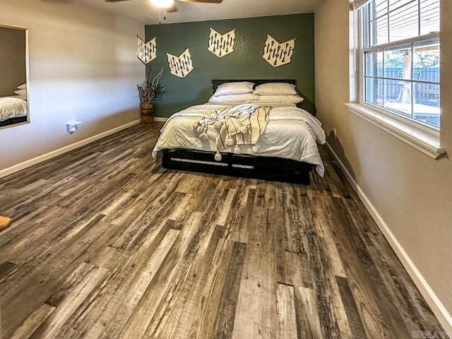 bedroom featuring wood finished floors, baseboards, and ceiling fan