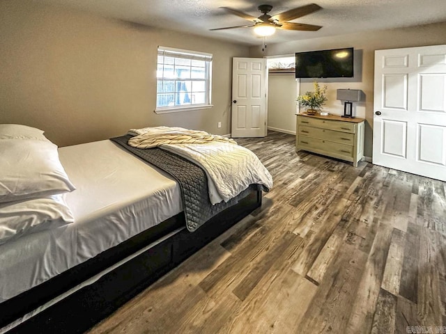 bedroom featuring wood finished floors and a ceiling fan