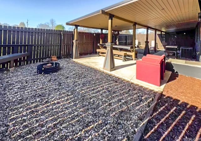 view of patio / terrace featuring a fenced backyard, an outdoor fire pit, and area for grilling