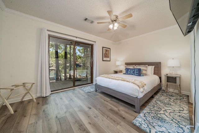 bedroom featuring a textured ceiling, visible vents, access to outside, crown molding, and hardwood / wood-style flooring