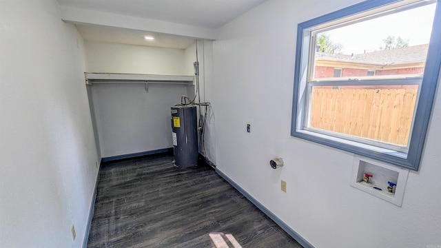 laundry area with water heater, dark wood-style floors, laundry area, hookup for a washing machine, and baseboards
