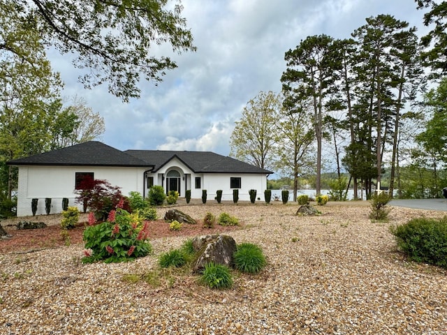 ranch-style home featuring stucco siding