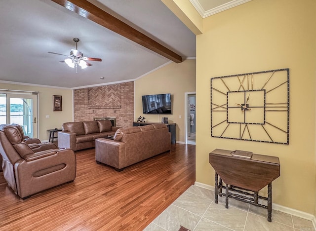 living area with baseboards, a fireplace, ceiling fan, and crown molding