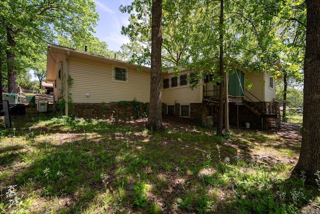 rear view of property with stairs